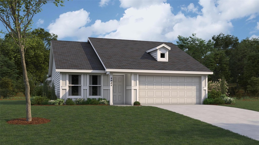 View of front of home with a garage and a front ya