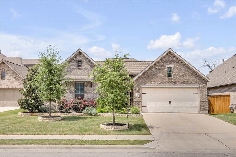 View of front of house with concrete driveway, a 