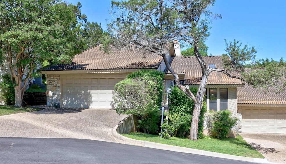 View of front of house featuring a garage, aphalt