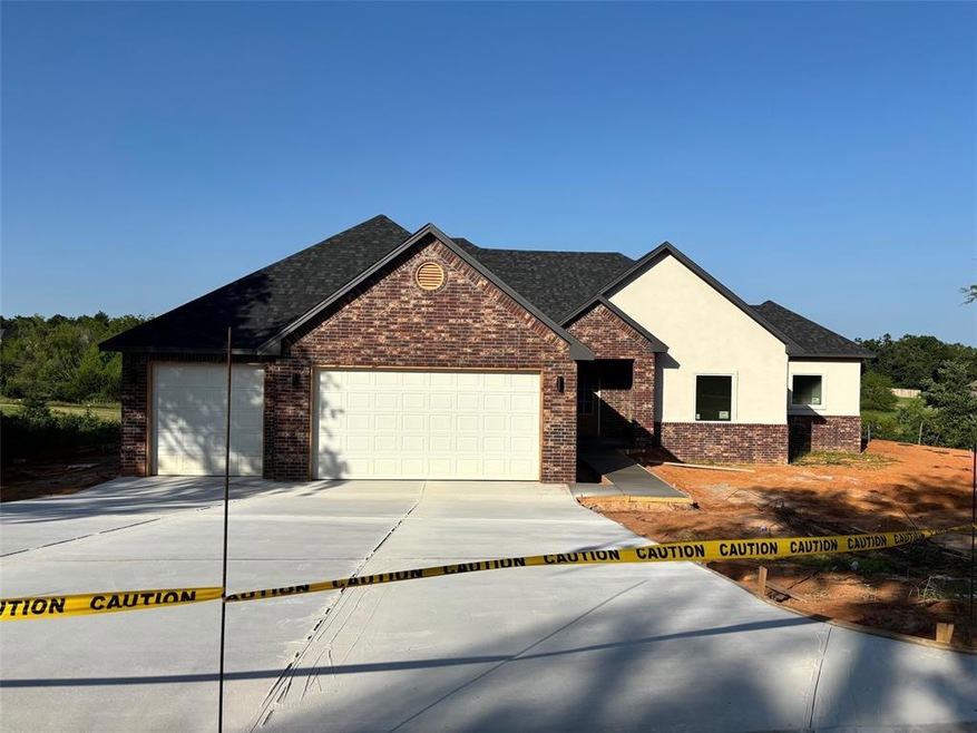 View of front of property with three car garage to