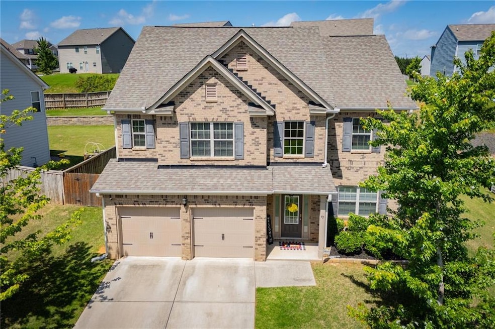 View of front of home with brick siding, a garage, concrete driveway, and a shingled roof