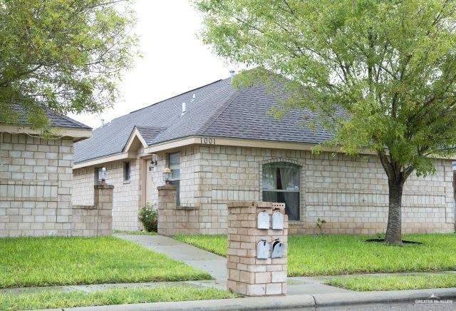 View of front of property with roof with shingles and a front yard