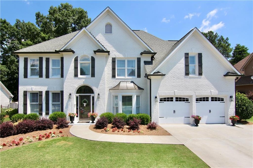 View of front of home with a garage and a front la