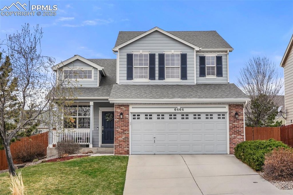 Traditional-style house with brick siding, roof wi