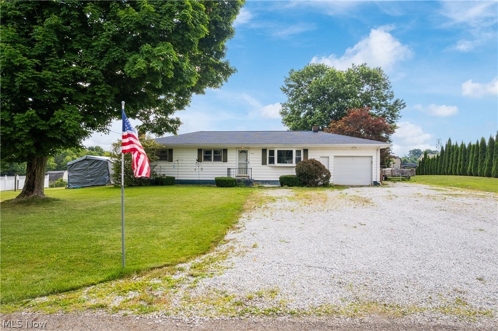 Ranch-style house with a front lawn and a garage
