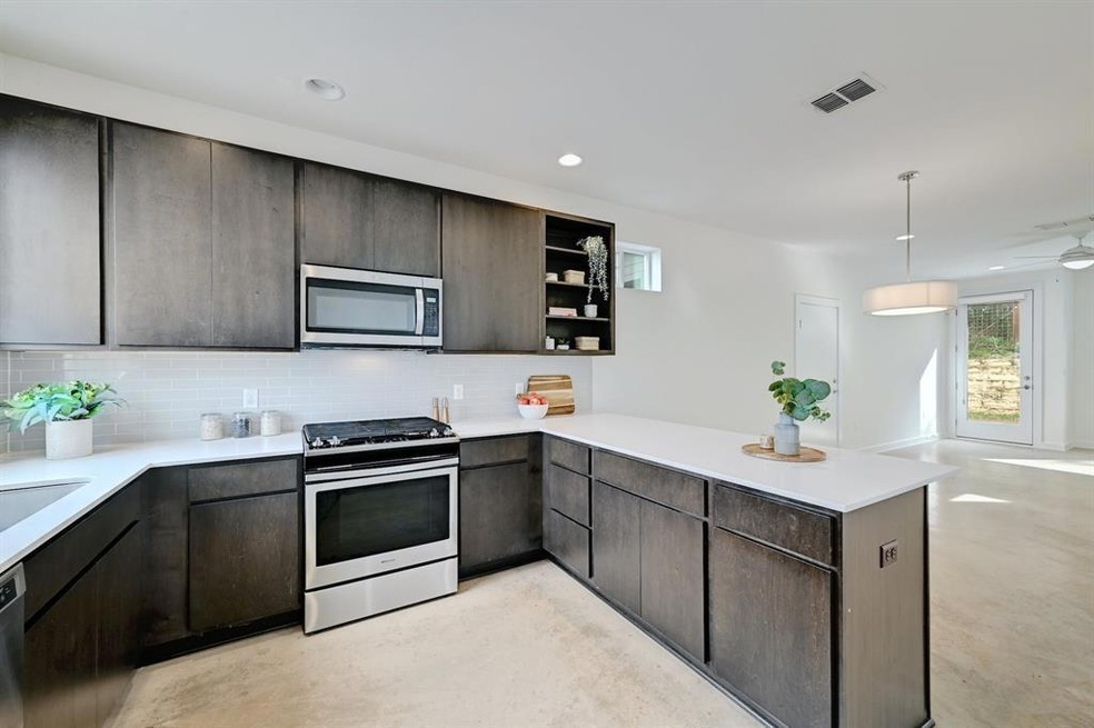 Kitchen with stainless steel appliances, a penins