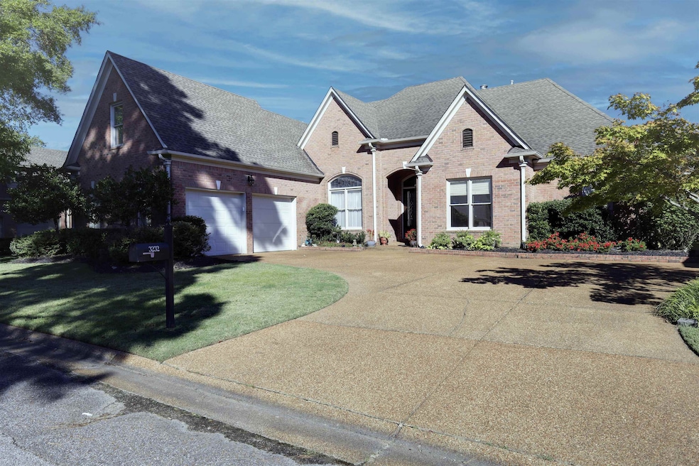 View of front of house featuring driveway, roof with shingles, brick siding, a front lawn, and an attached garage