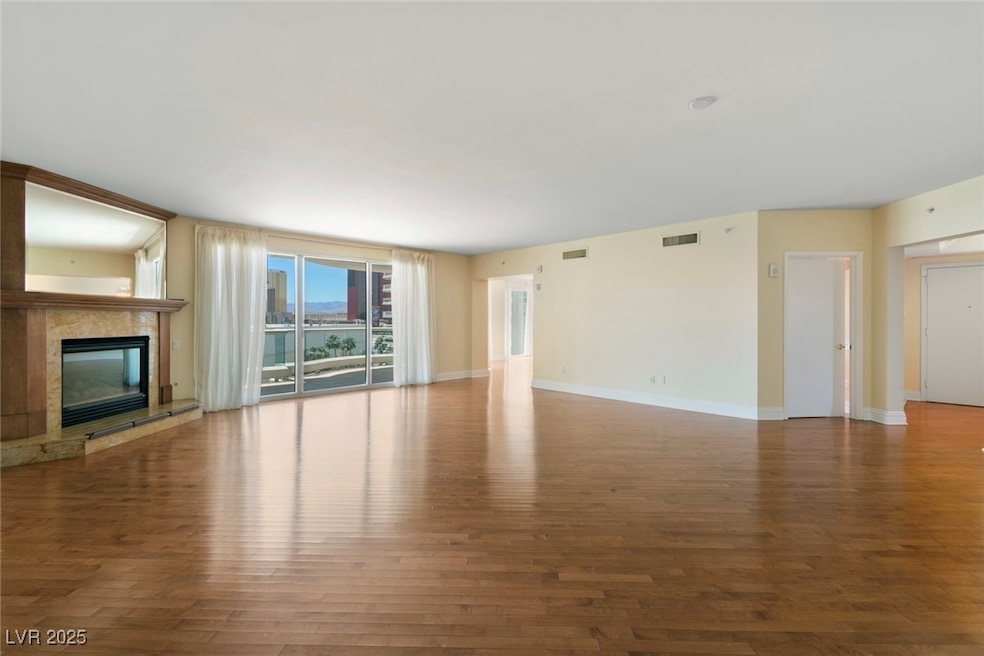 Unfurnished living room featuring wood finished fl