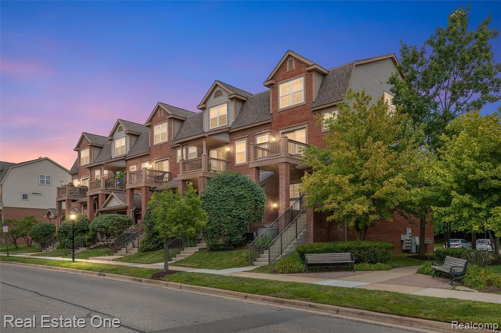 View of front of house featuring a residential view, brick siding, stairway, and a balcony