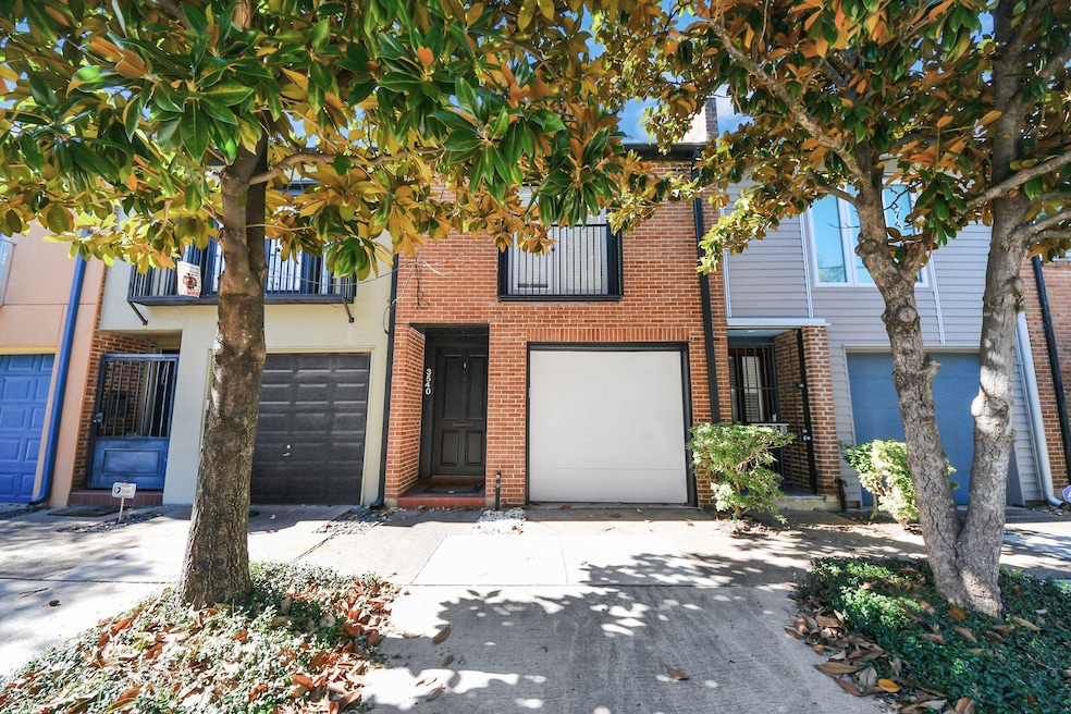 Welcome to this charming townhouse with a brick facade and modern design. It features a single car garage, a welcoming entrance.