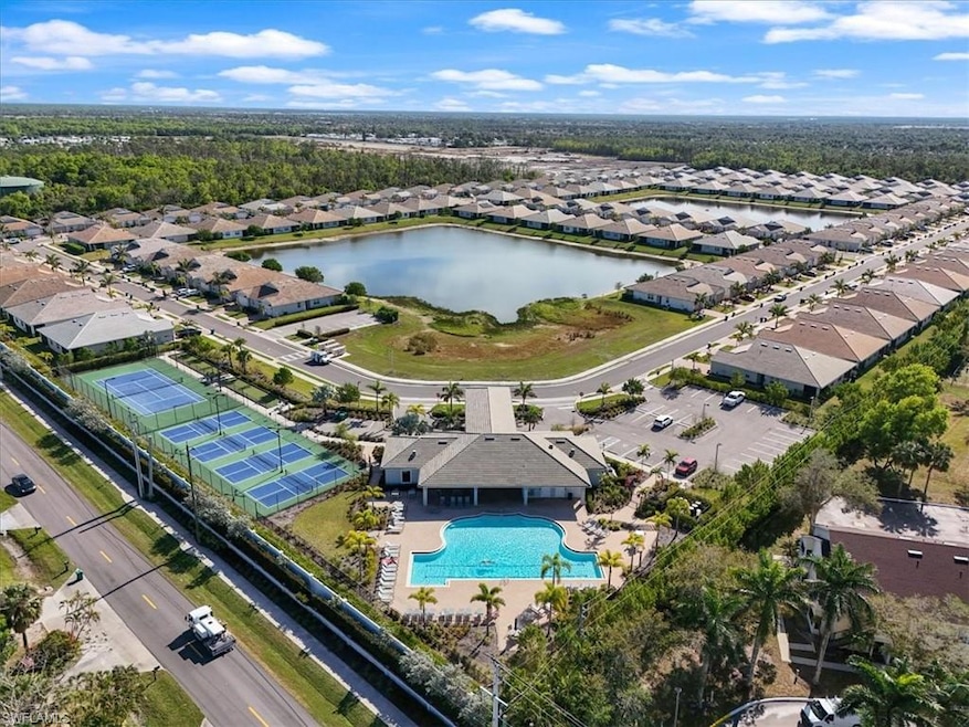 Birds eye view of property with a water view