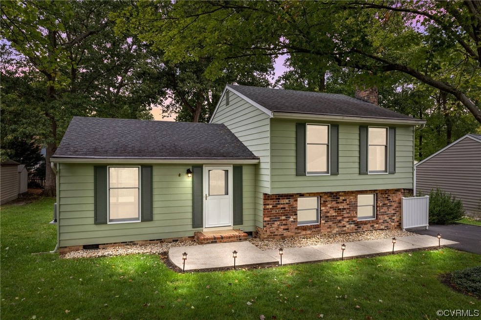 Tri-level home featuring a lawn
