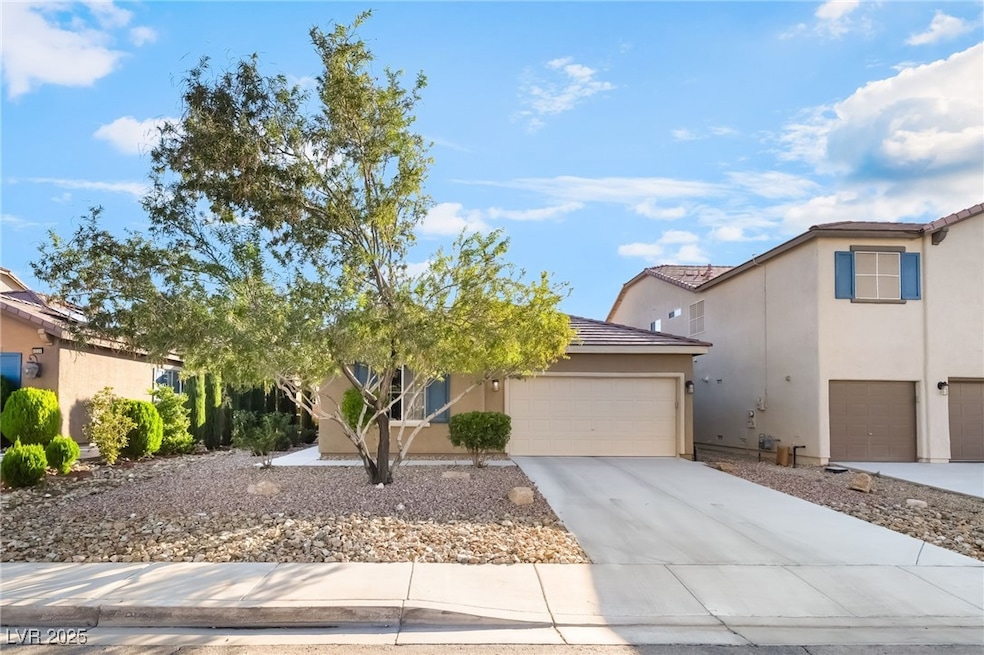 View of front of house with stucco siding, concrete driveway, and a garage