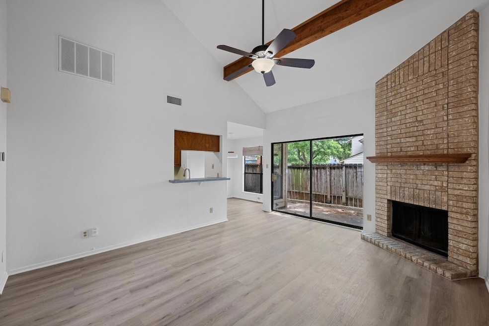 Unfurnished living room with high vaulted ceiling