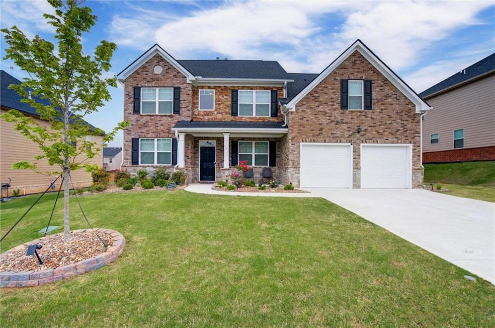 View of front facade featuring concrete driveway, 