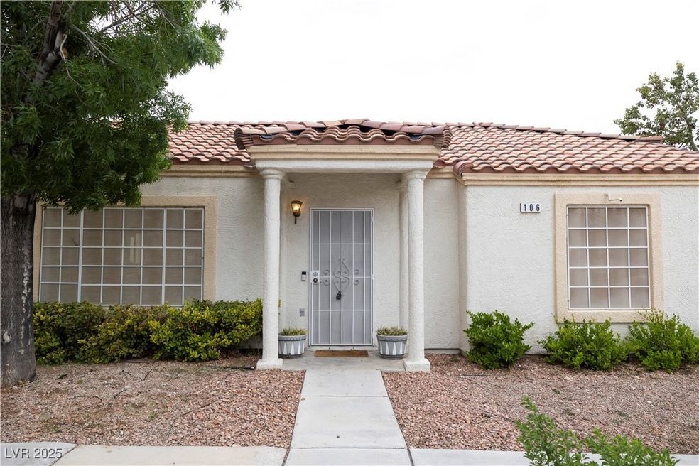 Property entrance with stucco siding and a tile ro
