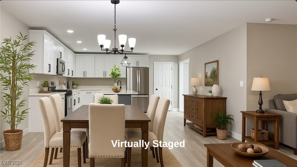 Dining area featuring light wood-type flooring, a chandelier, and recessed lighting