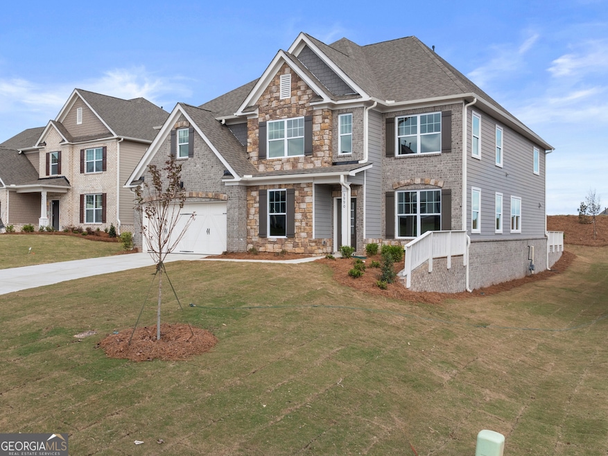 Westerly front exterior with brick and stone eleva