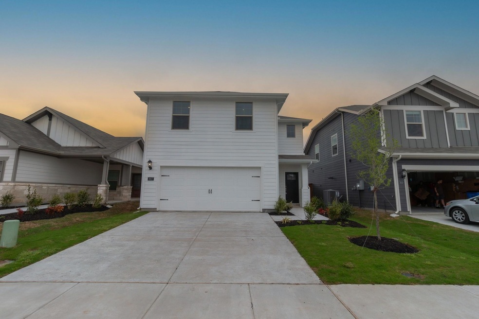 View of front of house featuring a lawn, an attach