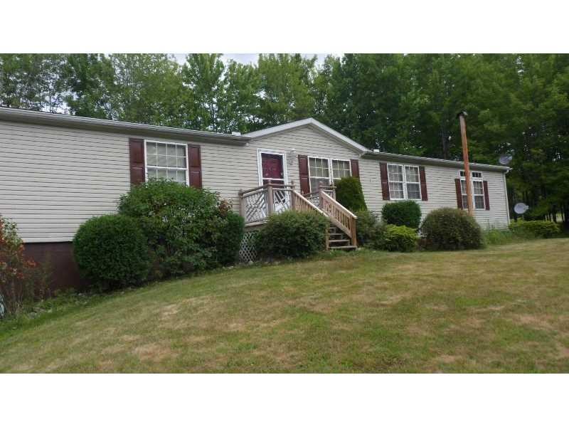 Exterior Front. Home sits on a hill and has a full