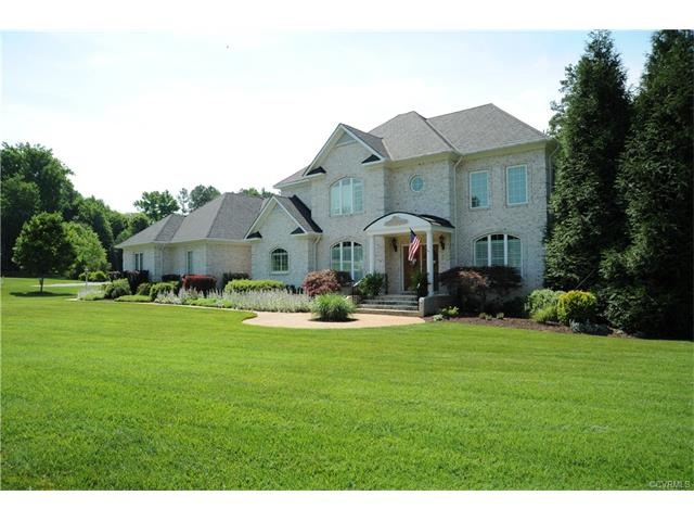Gorgeous all brick home with a grand manor roof on