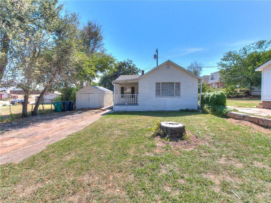 Rock exterior, covered porch, one-car detached garage, large lot