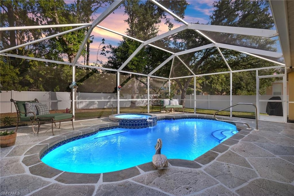 Pool at dusk featuring a lanai, a patio area, and 
