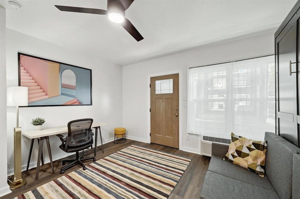 Office area with a ceiling fan, wood finished flo