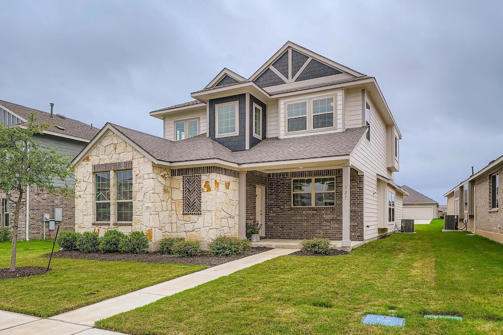 View of front of house with a front lawn, stone s