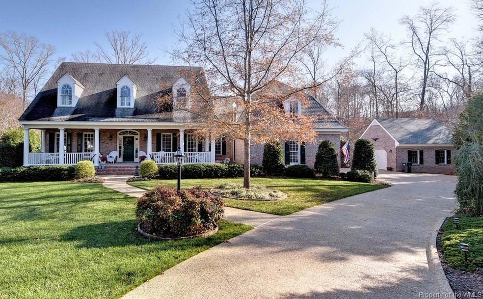 Front view showing driveway and detached garage.