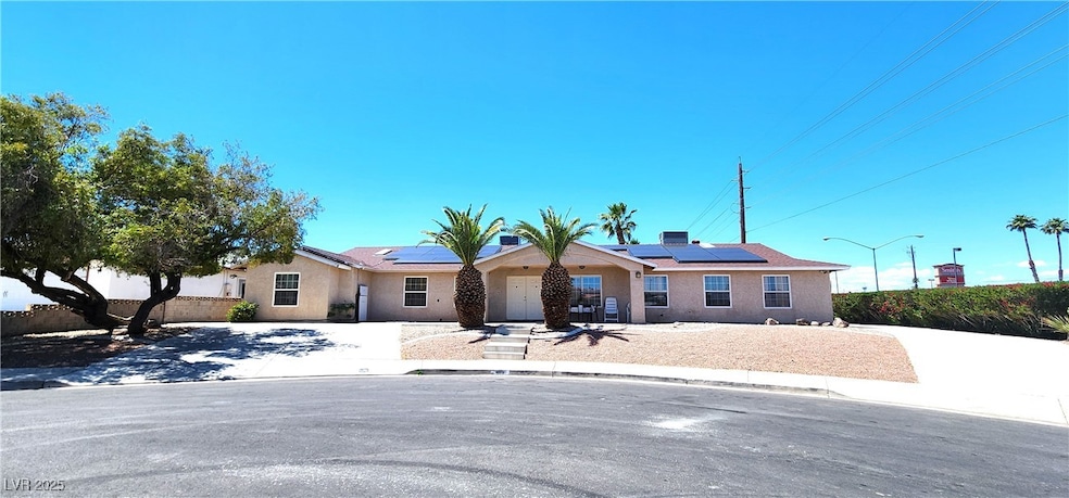 Ranch-style house featuring stucco siding, solar p