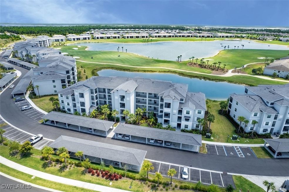 Drone / aerial view with golf course view and a wa