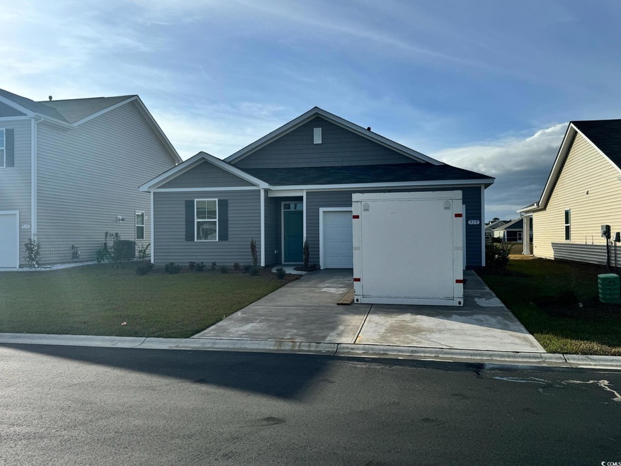 View of front of property featuring a garage and a