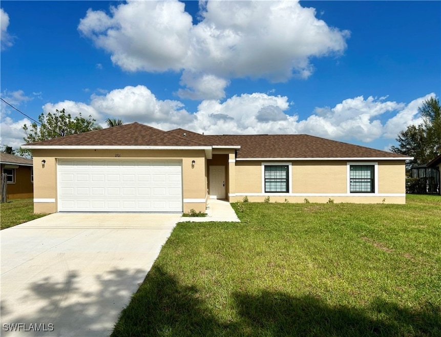 Single story home with a garage and a front yard