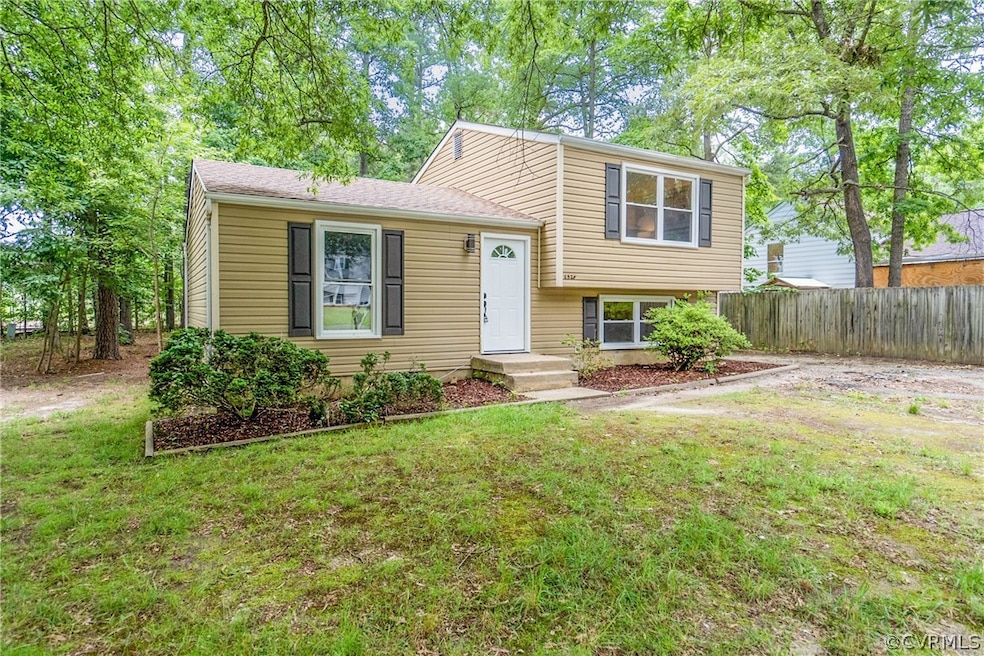 Tri-level home with a front lawn