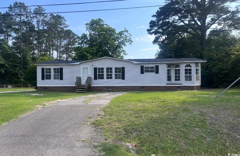 Manufactured / mobile home featuring crawl space, asphalt driveway, entry steps, and a front yard