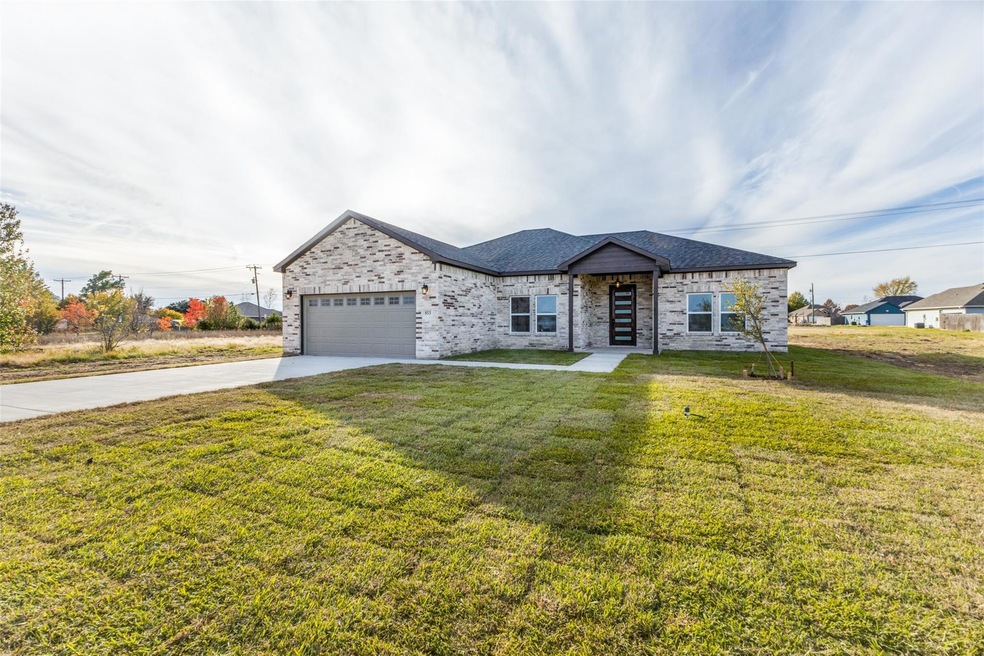 Ranch-style house with an attached garage, drivewa