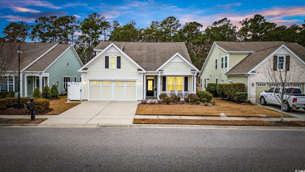 View of front facade featuring a porch and a garage