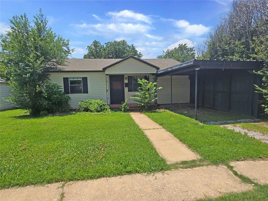 Ranch-style house with a front lawn and a carport