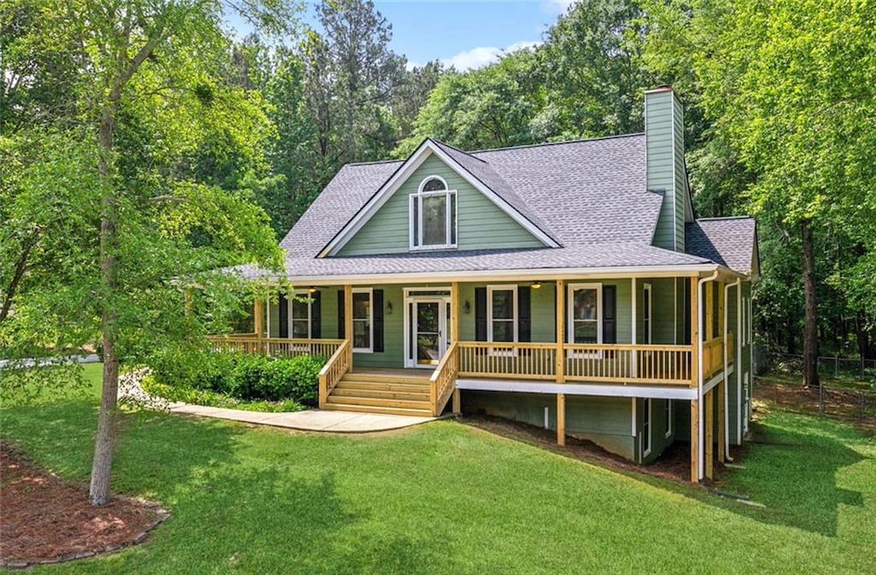 View of front of home featuring a front lawn and c