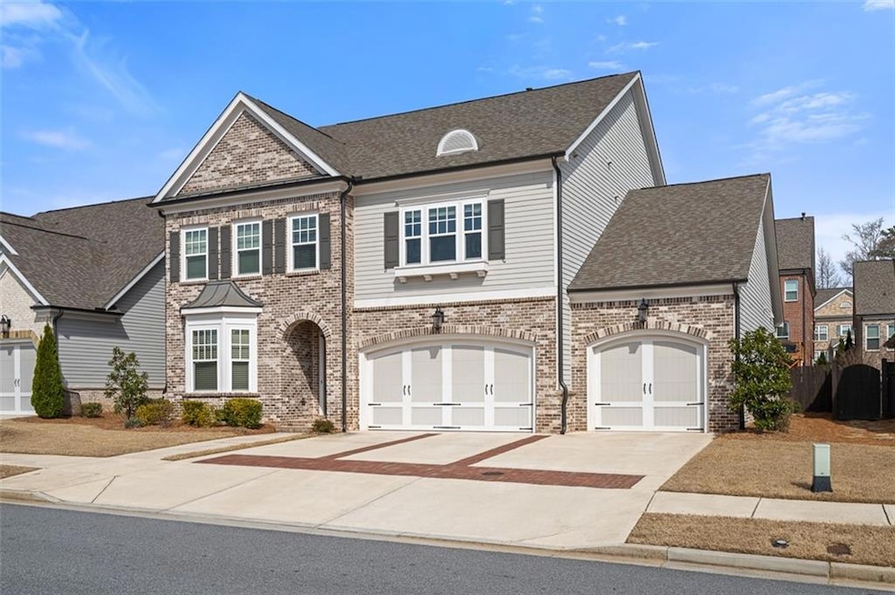 View of front of property featuring brick siding, concrete driveway, and a shingled roof