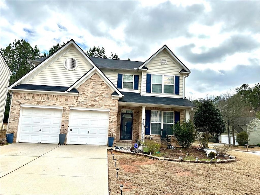 View of front of house with a garage, concrete dri