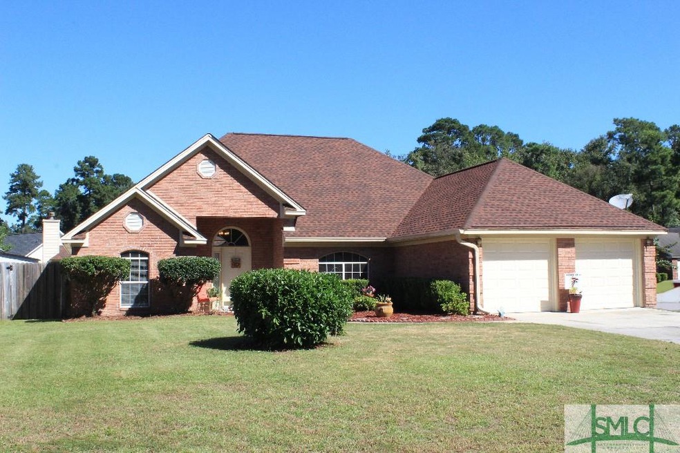 Brick front exterior and well-manicured lawn.
