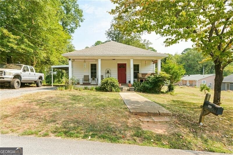 Bungalow with a porch and a front yard