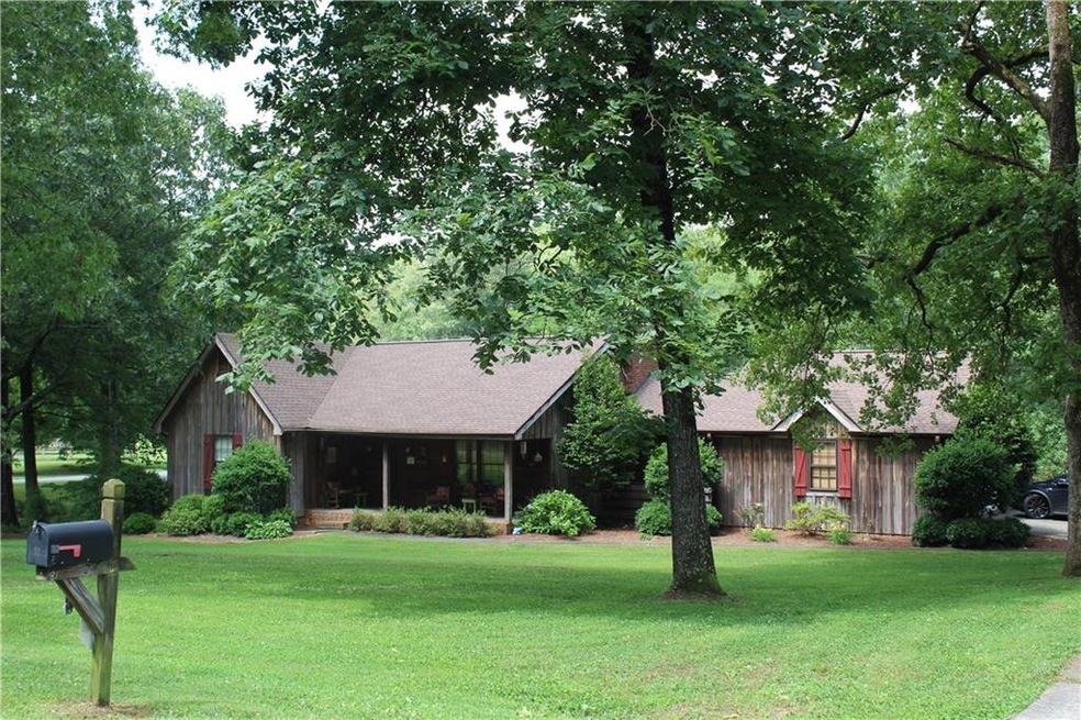 Rustic cypress wood siding ranch home on 1 acre co