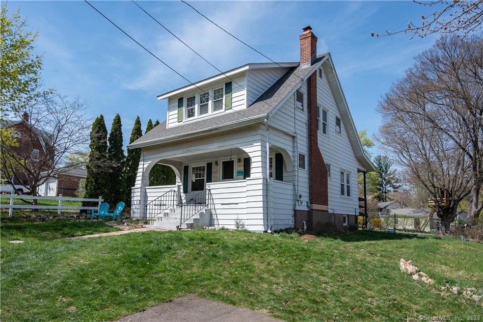 Perched overlooking the street & deep front yard