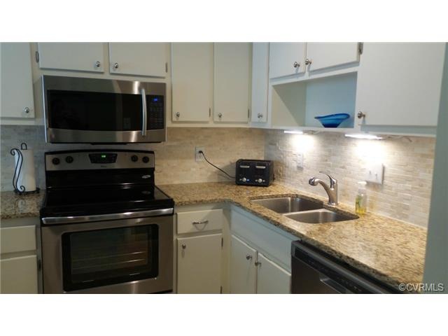 Remodeled kitchen with granite counter tops, back 