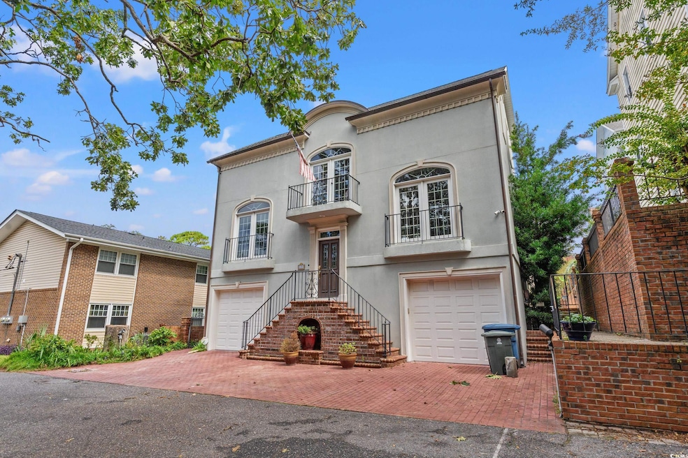 View of front of home featuring a balcony and a garage
