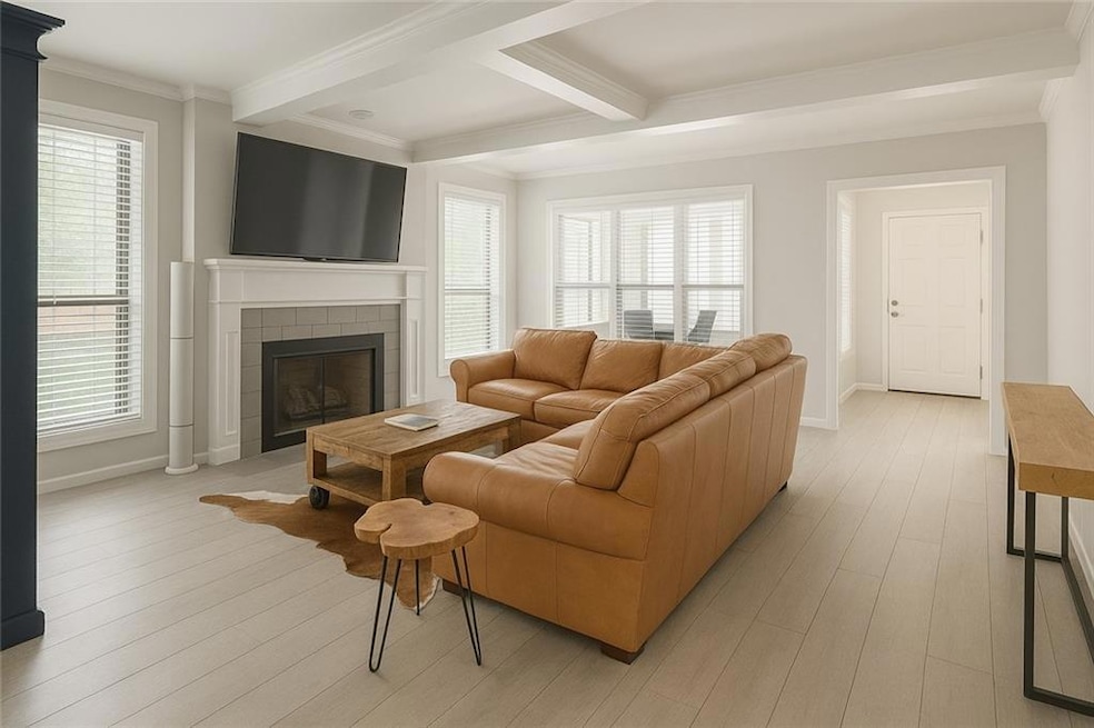 Living room with crown molding, light wood finishe