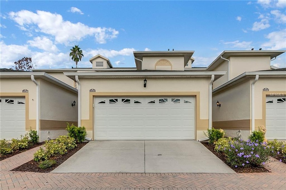 Exterior double car garage entry with brick sidewa